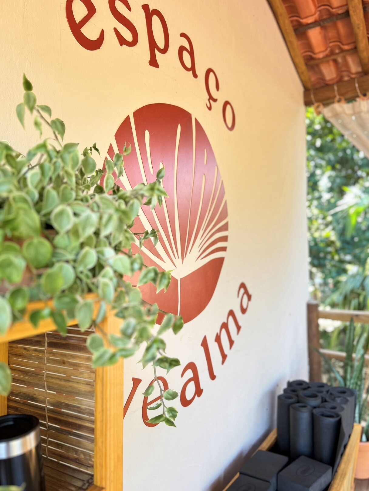 The Espaço Leve Alma sign on the studio wall, mats rolled below
